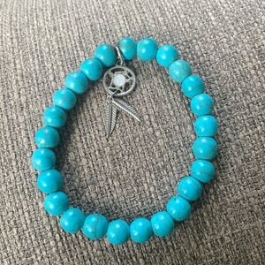 Bright blue bracelet with dream catcher charm